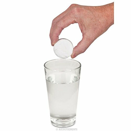 Hand dropping a large tablet into a glass of water.