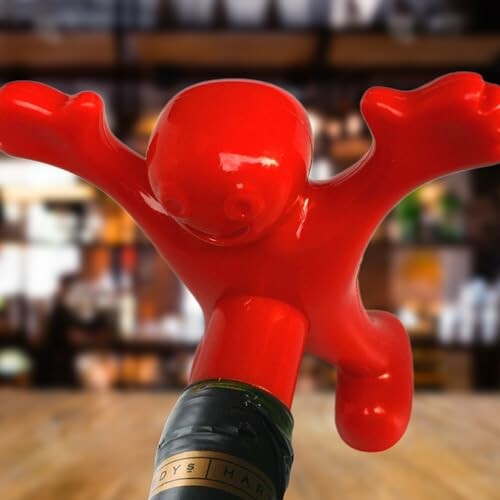 Red figure bottle opener on a bottle